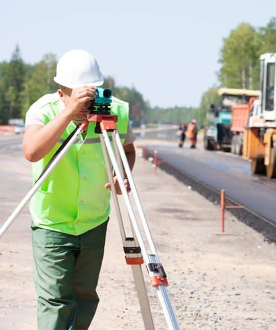 Surveyor Looking at Theodolite — Premium Pegs for Surveying & More in Heatherbrae, NSW